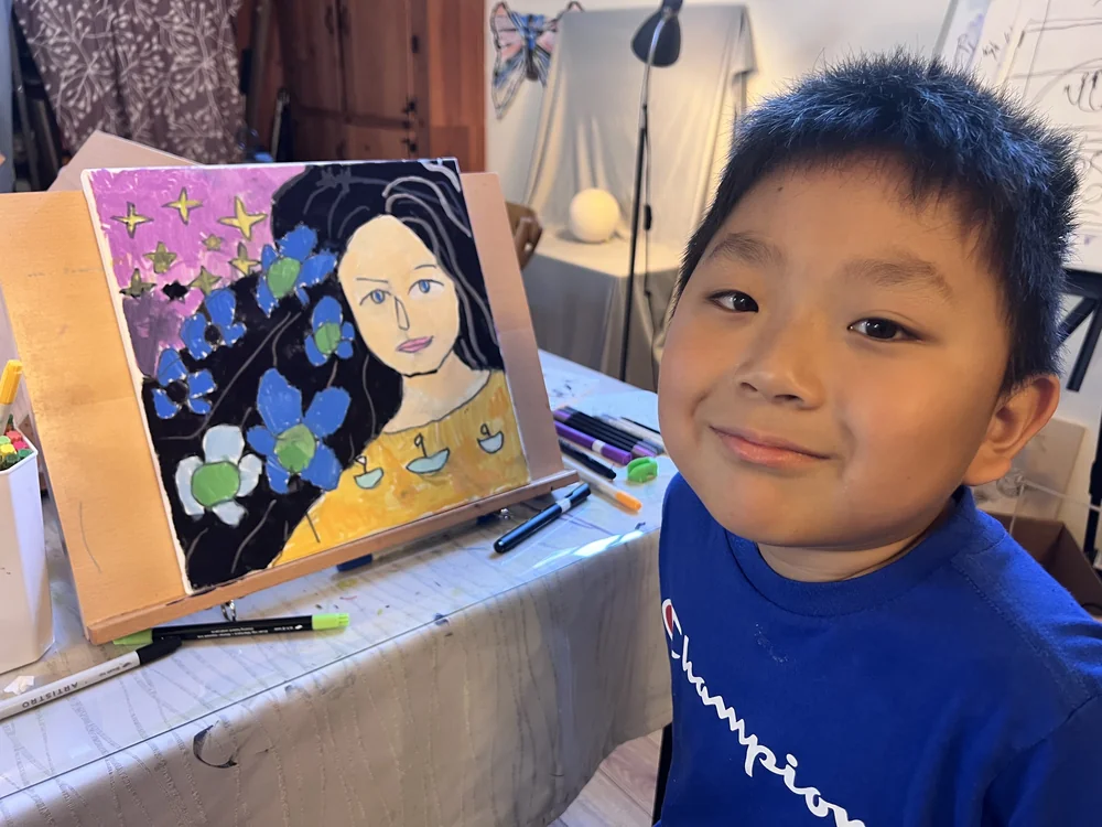 Student drawing at a table